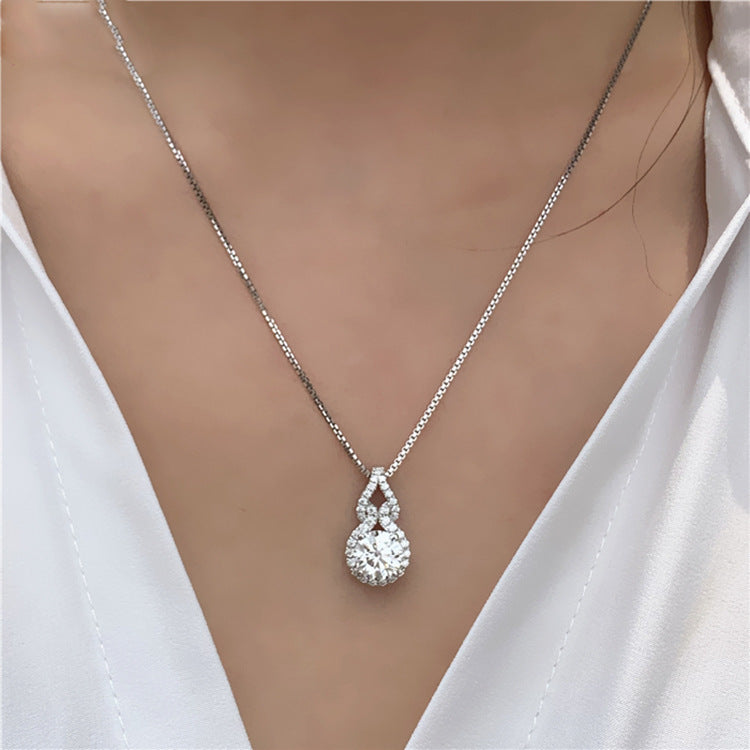 Halo solitaire pendant necklace worn with a white shirt