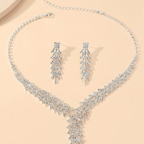 Aveline silver-tone crystal necklace and fringe drop earrings laid flat