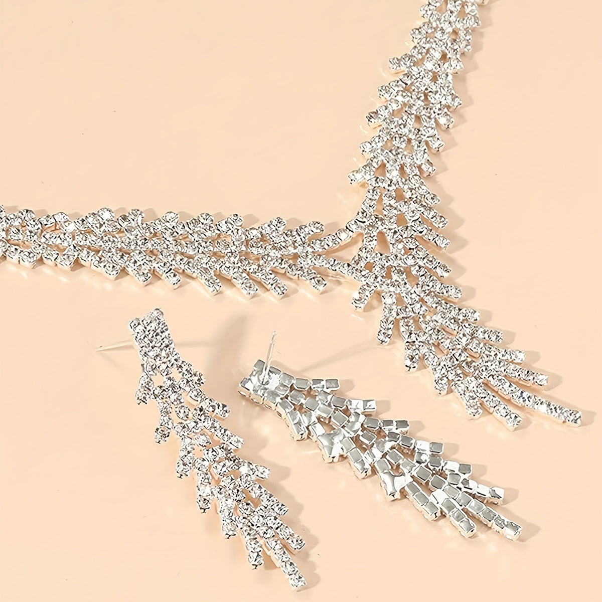 Close-up of the Aveline necklace's crystal V-drop and matching earrings