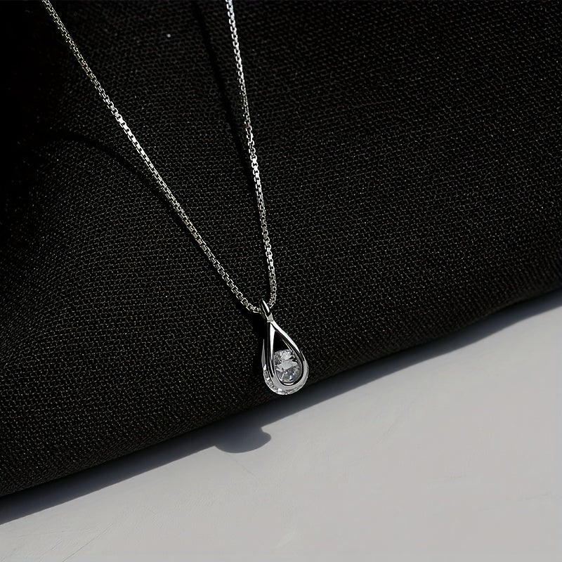 Petite Larme minimalist teardrop necklace on black fabric
