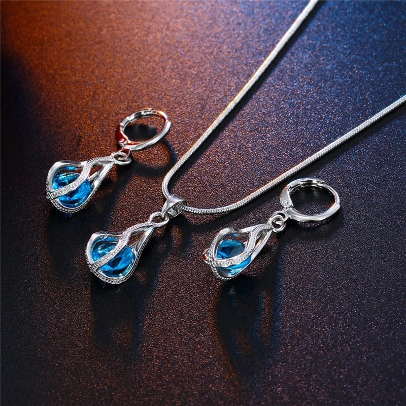 Sky blue Crystal Drop necklace and earrings on a dark background