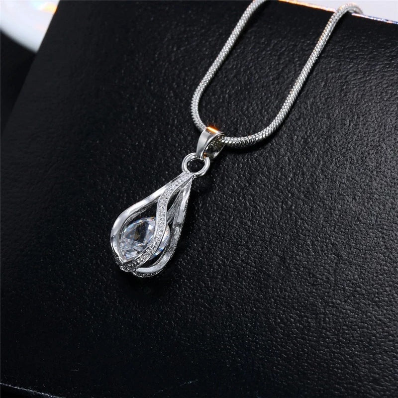 Close-up of the clear Crystal Drop teardrop pendant on a snake chain