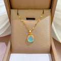 Moonlit Drop necklace: turquoise drop pendant on a gold-tone chain in a gift box