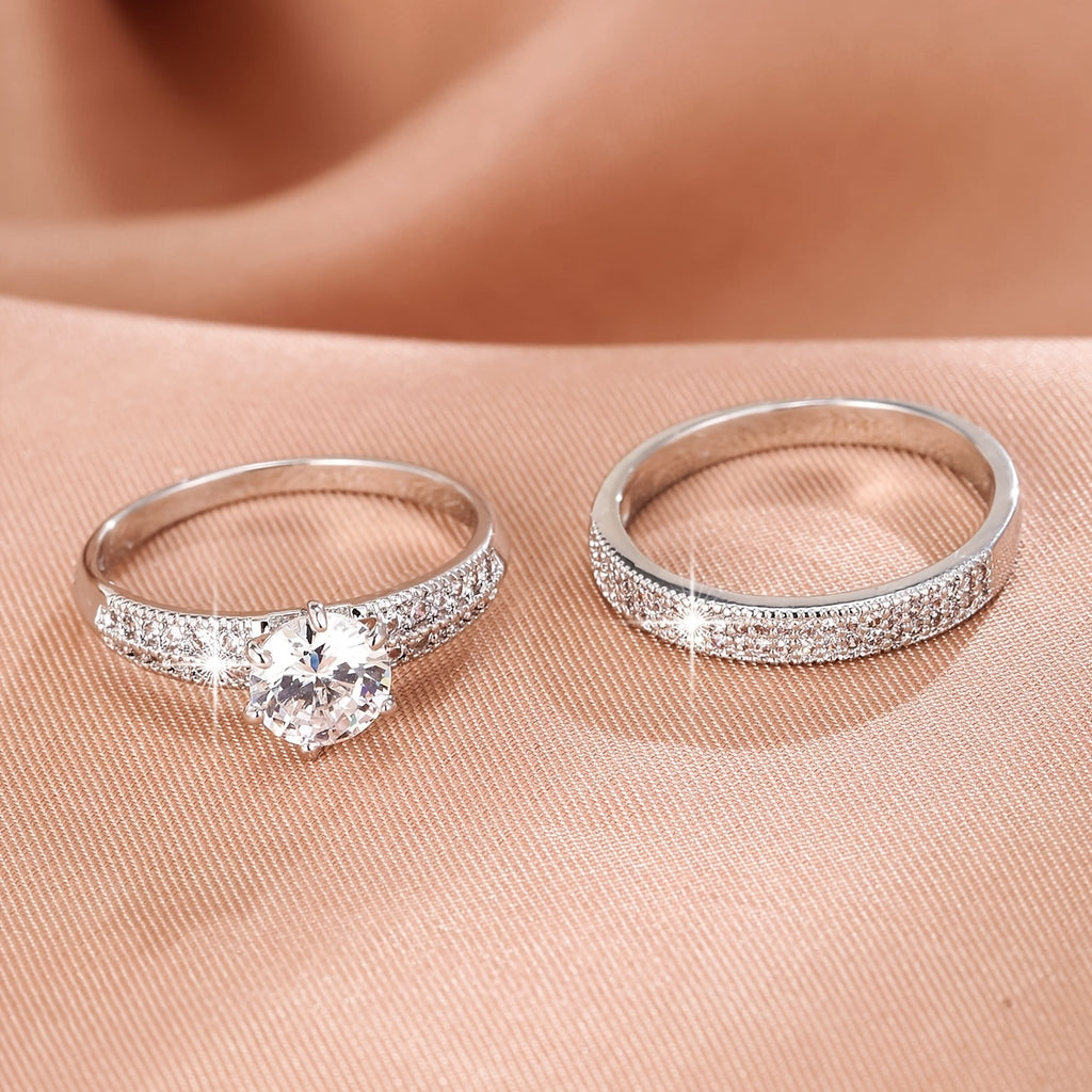 Éternité solitaire ring and eternity band side by side on satin