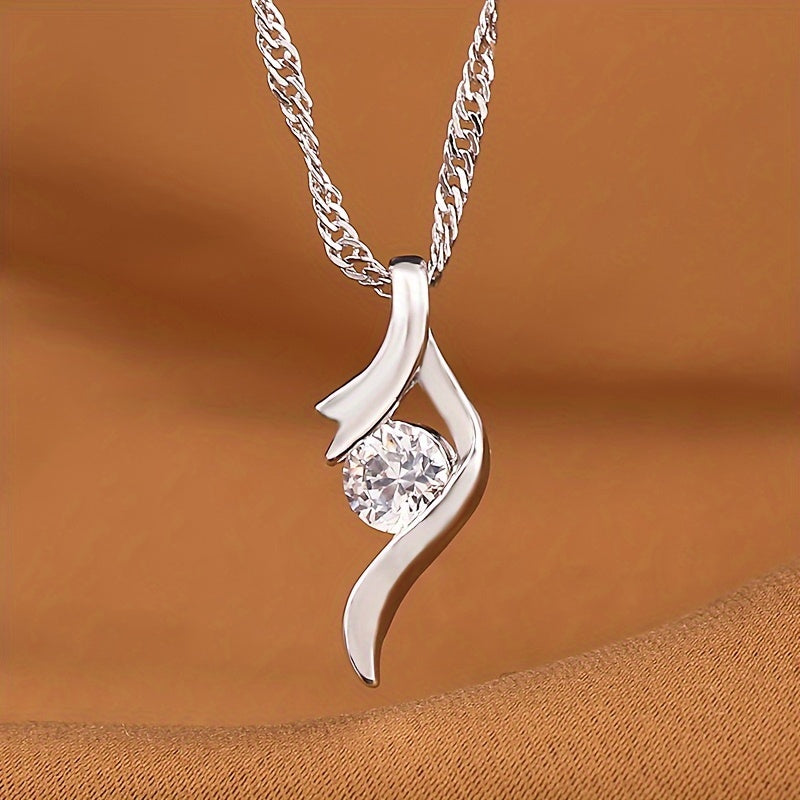 Ondine pendant: round clear zirconia cradled in an open silver-tone ribbon