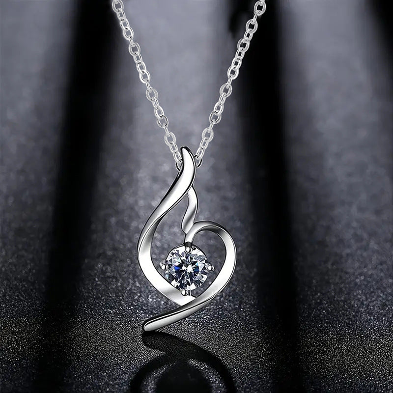 Lumière clear crystal heart pendant on a dark background