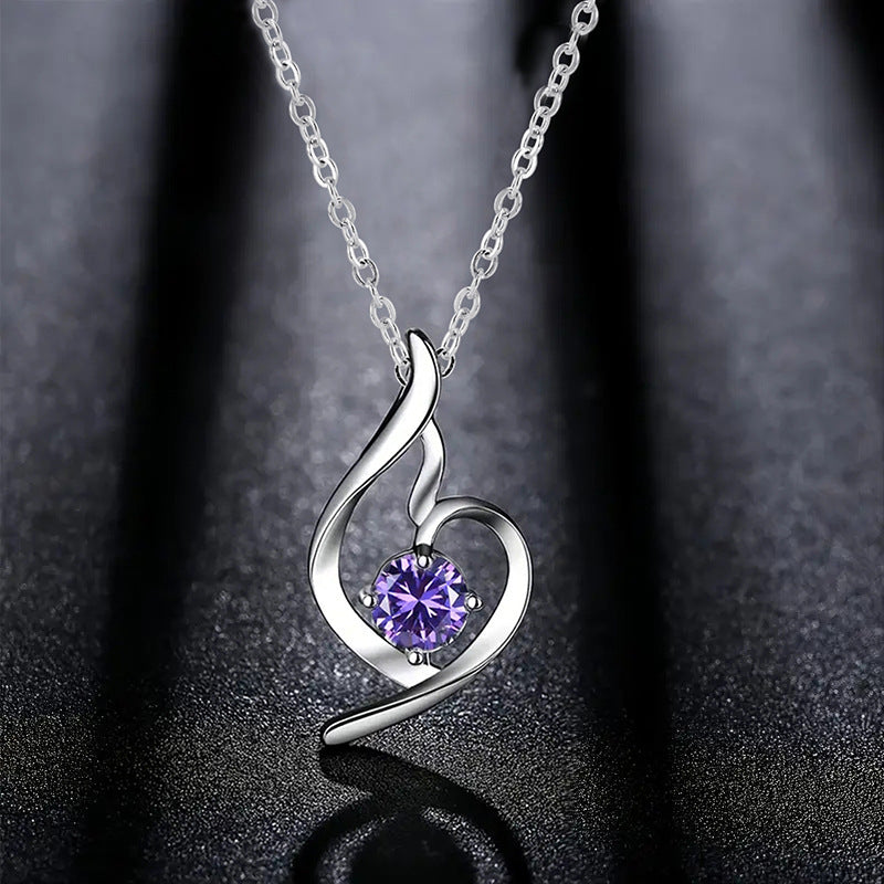 Lumière violet crystal heart pendant on a dark background