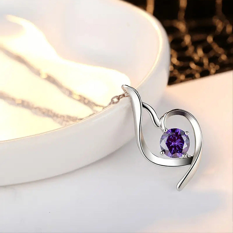 Lumière violet heart pendant on a white dish