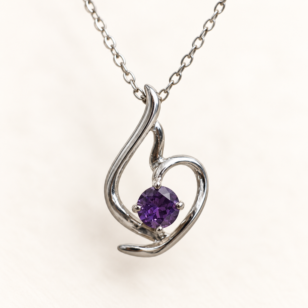Lumière silver-tone heart pendant with a round violet stone – macro of the stone and setting