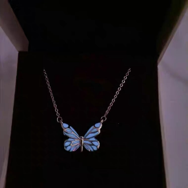 Luminous butterfly necklace glowing in a gift box