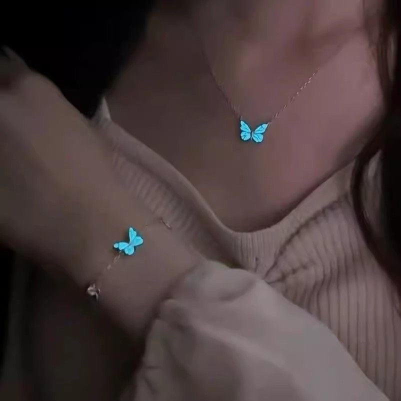 Glow-in-the-dark butterfly necklace and bracelet worn at night