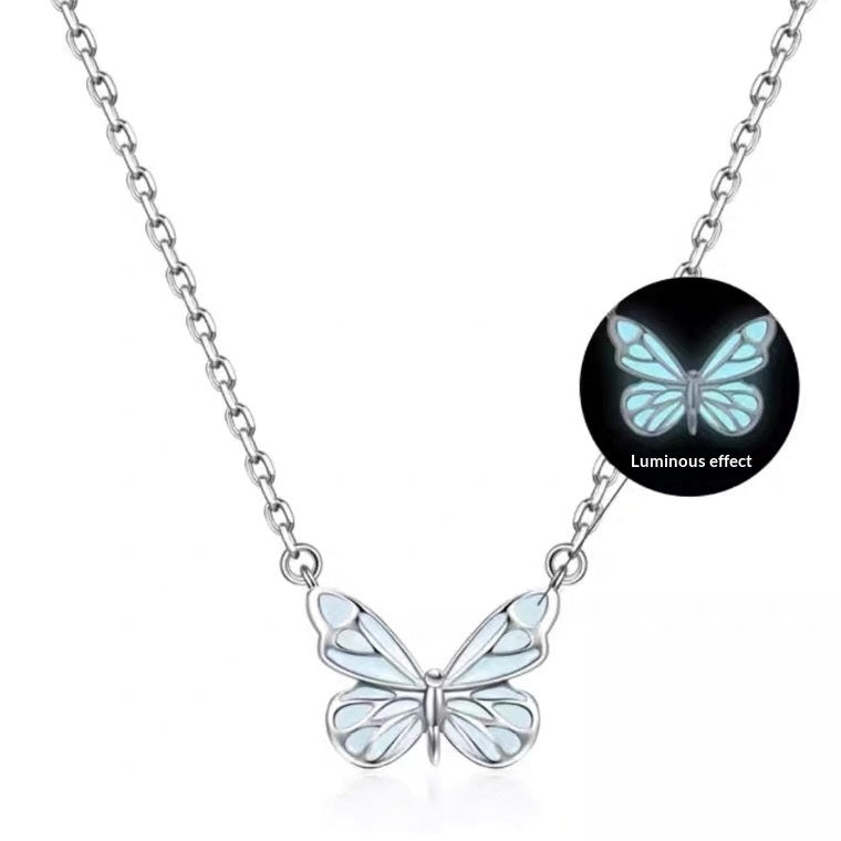 Luminous butterfly pendant on white, with an inset showing the glow effect