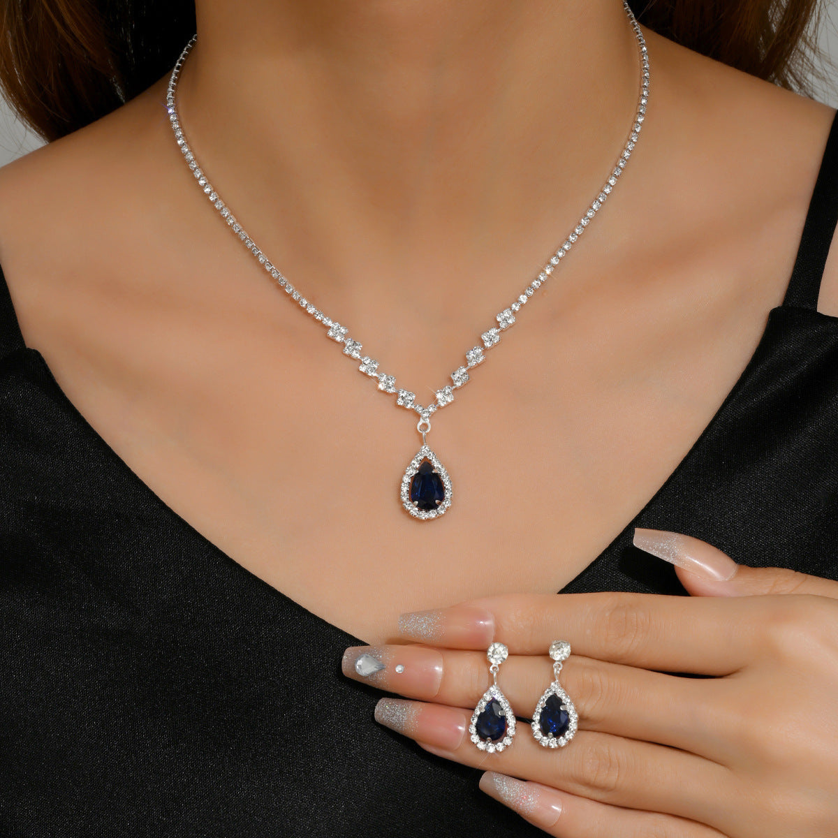 Soirée Drop Set in navy worn with matching teardrop earrings