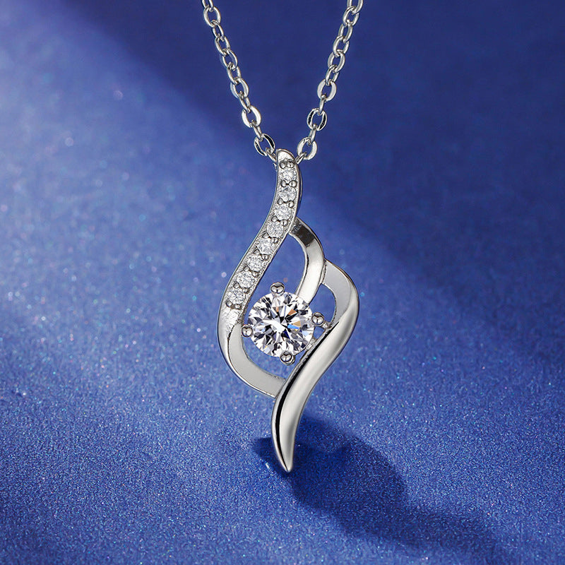 Twist of Heart silver-tone pendant on blue fabric